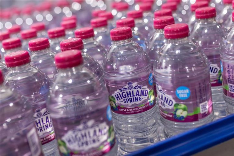 Highland Spring Apple & Blackcurrant Still Spring Water bottles on production line – sugar-free flavoured spring water from Scotland.